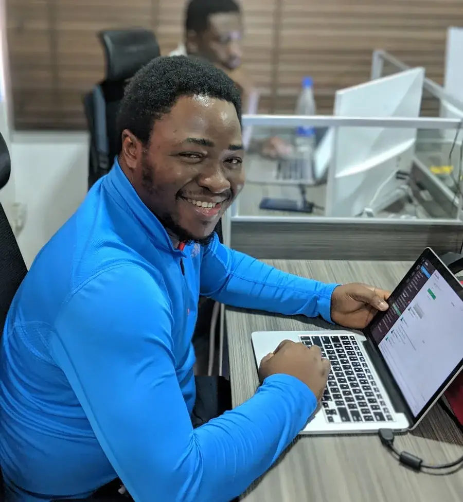 Cybersecurity advisor working on a laptop in Kampala Uganda